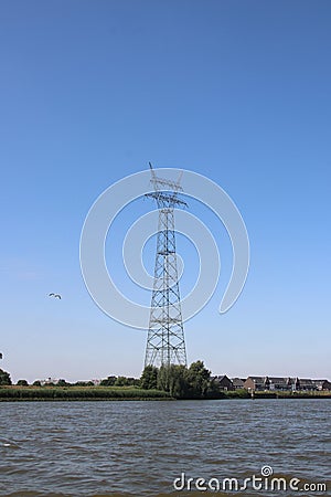 Extra high power tower over river Lek in the Netherlands Stock Photo
