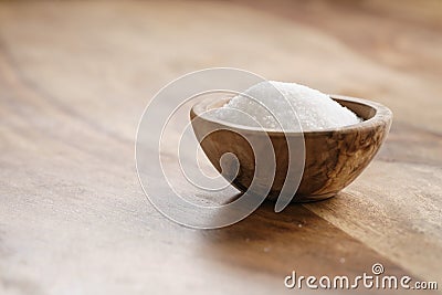 Extra sea salt in wood bowl on wooden table Stock Photo