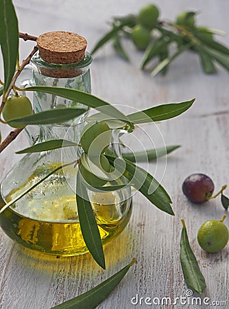 Extra-virgin olive oil bottle and green olivas Stock Photo