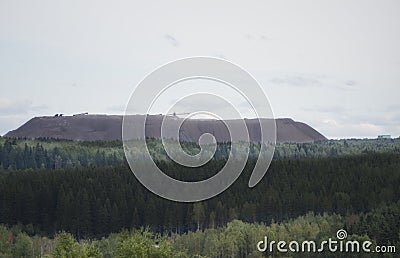 Extracting and mining potassium and magnesium salts.Large excavator machine and Huge mountains of waste ore in the extraction of p Stock Photo