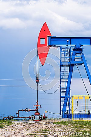 Extraction of crude oil in oilfield. Oil drilling rig pumps oil. Stock Photo