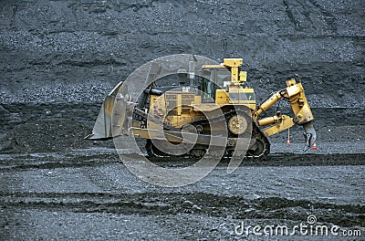 Extraction of minerals. Heavy powerful bulldozer in the quarry Editorial Stock Photo