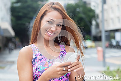 Extraordinary woman with red hair typing message at phone Stock Photo