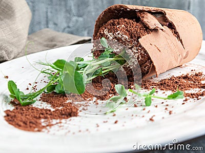 Extravagant dessert. `Broken Flower ` Belgian milk chocolate combined with sponge cake, blueberry dressing, butter cream and choco Stock Photo