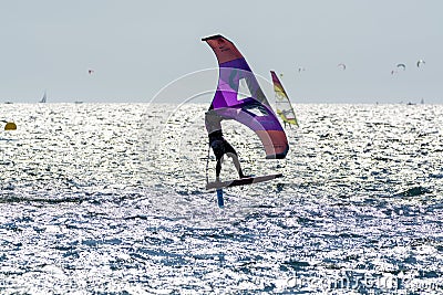 Hyeres, Almanarre beach, France, July 10, 2021. Extreem water sport - wing foil, kite surfing, wind surfindg, windy day on Editorial Stock Photo