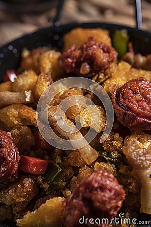 Extremadura crumbs, typical plate of Extremadura, breadcrumbs, bacon, red and green pepper, garlic and paprika, with a glass of Stock Photo