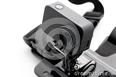 Extreme action camera with chest mount isolated on a white background. Camera for footage 4k movies, sports and domestic life. Stock Photo