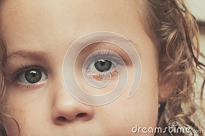 Extreme close up beautiful blue eyes toddler girl portrait - Child face extreme close up with copy space - Stock Photo