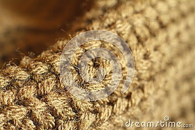 Extreme close-up ocher color knitted natural wool sweater texture, wavy folds, selective focus Stock Photo