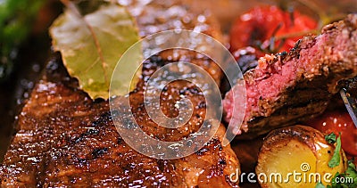 Extreme close up view of a sirloin steak with asparagus, potatoes and roasted tomatoes Stock Photo