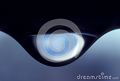 Extreme close up of a water droplet hanging in suspension about to fall Stock Photo