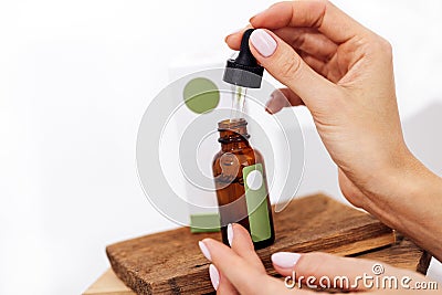 Extreme close up of womans hand and pipette Stock Photo