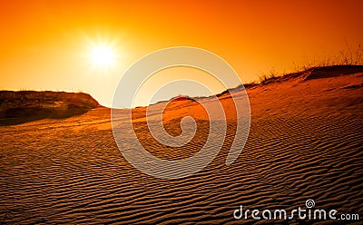 Extreme desert landscape with orange sunset. Stock Photo