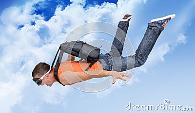 Extreme flight man with a parachute in the clouds Stock Photo