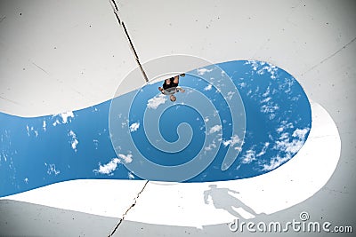 Extreme man with big shadow silhouette preparing for the jump over the gap between concrete walls Stock Photo