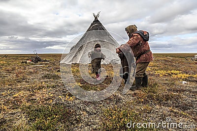 The extreme north, Yamal, the past of Nenets people, the dwelling of the peoples of the north, a children playing near the yurts i Stock Photo