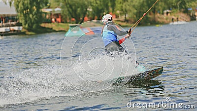 Extreme Park, Kiev, Ukraine, 07 may 2017 - a young girl, accustomed to ride Wakeboarding. Photo of grain processing Editorial Stock Photo