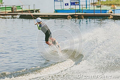 Extreme Park, Kiev, Ukraine - may, 07, 2017 - a young man practiced jumping at Wakeboarding. Photo processing grain. Editorial Stock Photo