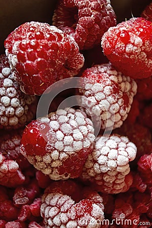 Extreme shallow depth of field. Selective focus of Bunch of Frozen rasberries macro shot kept together in a bowl Stock Photo