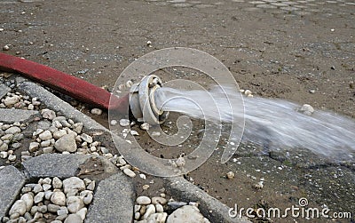 Extreme weather - water being pumped out of a flooded basement Stock Photo