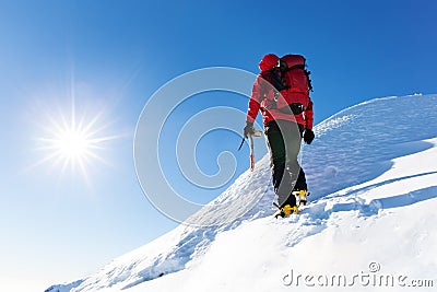 Extreme winter sports: climber at the top of a snowy peak in the Stock Photo