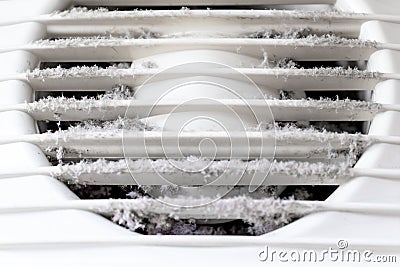 Extremely dirty and dusty white plastic ventilation air grille at home close up, harmful for health Stock Photo