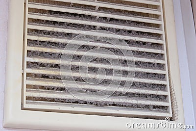 Extremely dirty and dusty white plastic ventilation air grille at home close up, harmful for health, house cleaning concept Stock Photo