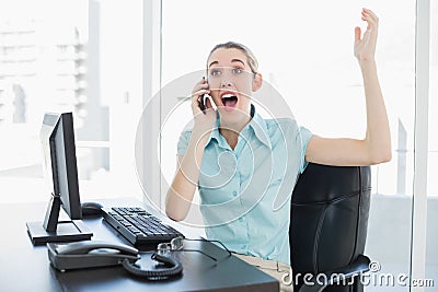 Extremely happy chic businesswoman phoning while cheering Stock Photo