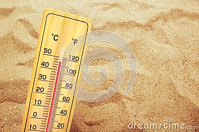 Extremely high temperatures, thermometer on warm desert sand Stock Photo