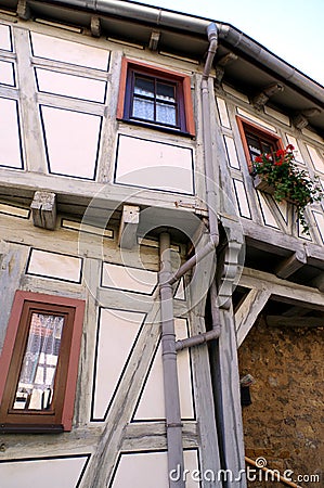 Part of a renovated and well-kept half-timbered house with a very small window 2 Stock Photo