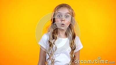 Extremely surprised girl with big eyes looking to cam, shocked with news, promo Stock Photo