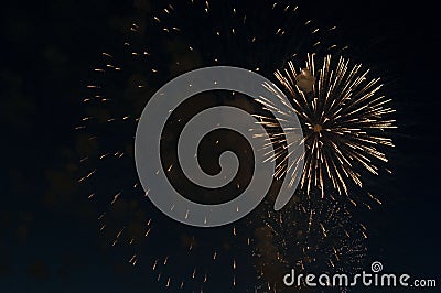 Extremley cheap firework over the city, orange and yellow Stock Photo