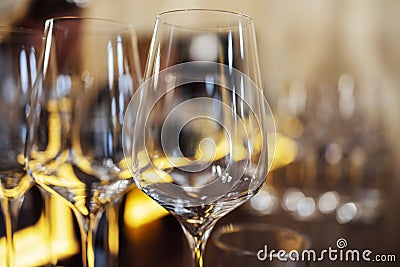 Extrime closeup of empty champagne glasses in a row. Wine goblet at wedding reception, alcohol bar, catering in restaurant Stock Photo