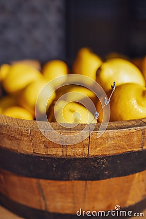 Extrime closeup of vertical view of a wooden bucket full of fresh lemons and sprig of lavender Stock Photo