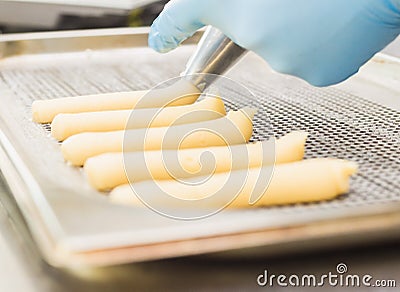 Extruded through a nozzle pastry choux pastry, cake forms Stock Photo
