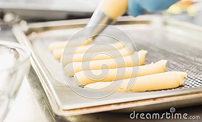 Extruded through a nozzle pastry choux pastry, cake forms Stock Photo