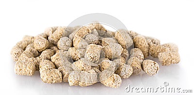 Extruded wheat bran pellets isolated on white. Stock Photo