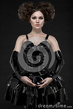 Exy woman brunette in fetish latex dress and chains Stock Photo