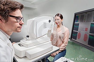 Eye care professional doing an OCT SLO retinal analysis Stock Photo