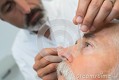 Eye while doctor applying eye drop Stock Photo