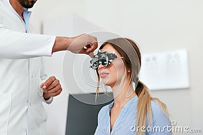 Eye Exam. Woman In Glasses Checking Eyesight At Clinic Stock Photo