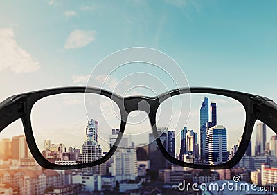 Eye glasses looking to city view, focused on glasses lens Stock Photo