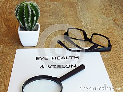 Eye health and vision note written on a white paper. Stock Photo