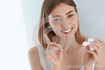 Eye lens. Smiling woman with contact eye lenses and container Stock Photo