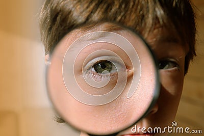 Eye through a magnifying glass. Look through the magnifier. Stock Photo