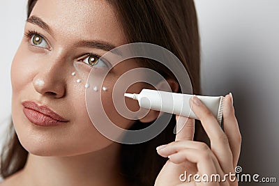 Eye Skin Care. Beautiful Woman Applying Eye Cream Stock Photo