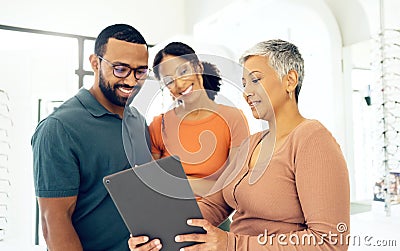 Eye test results, talking and woman with a couple, glasses and a tablet for online information. Optometry, happy and a Stock Photo