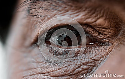 Eye, vision and wrinkles with a senior person closeup for sad emotion, pain or grief on an expressive face. Healthcare Stock Photo