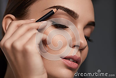 Eyebrows Contouring. Beautiful Woman With Brown Eyebrow Pencil Stock Photo