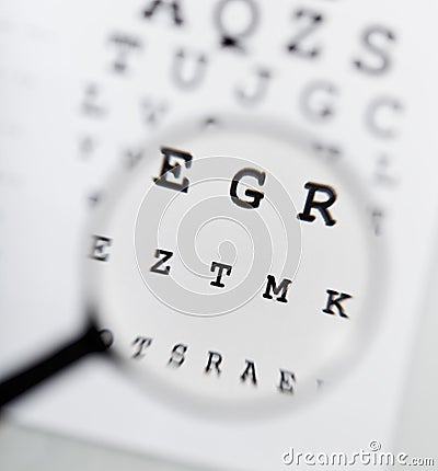 Eyechart and magnifier Stock Photo